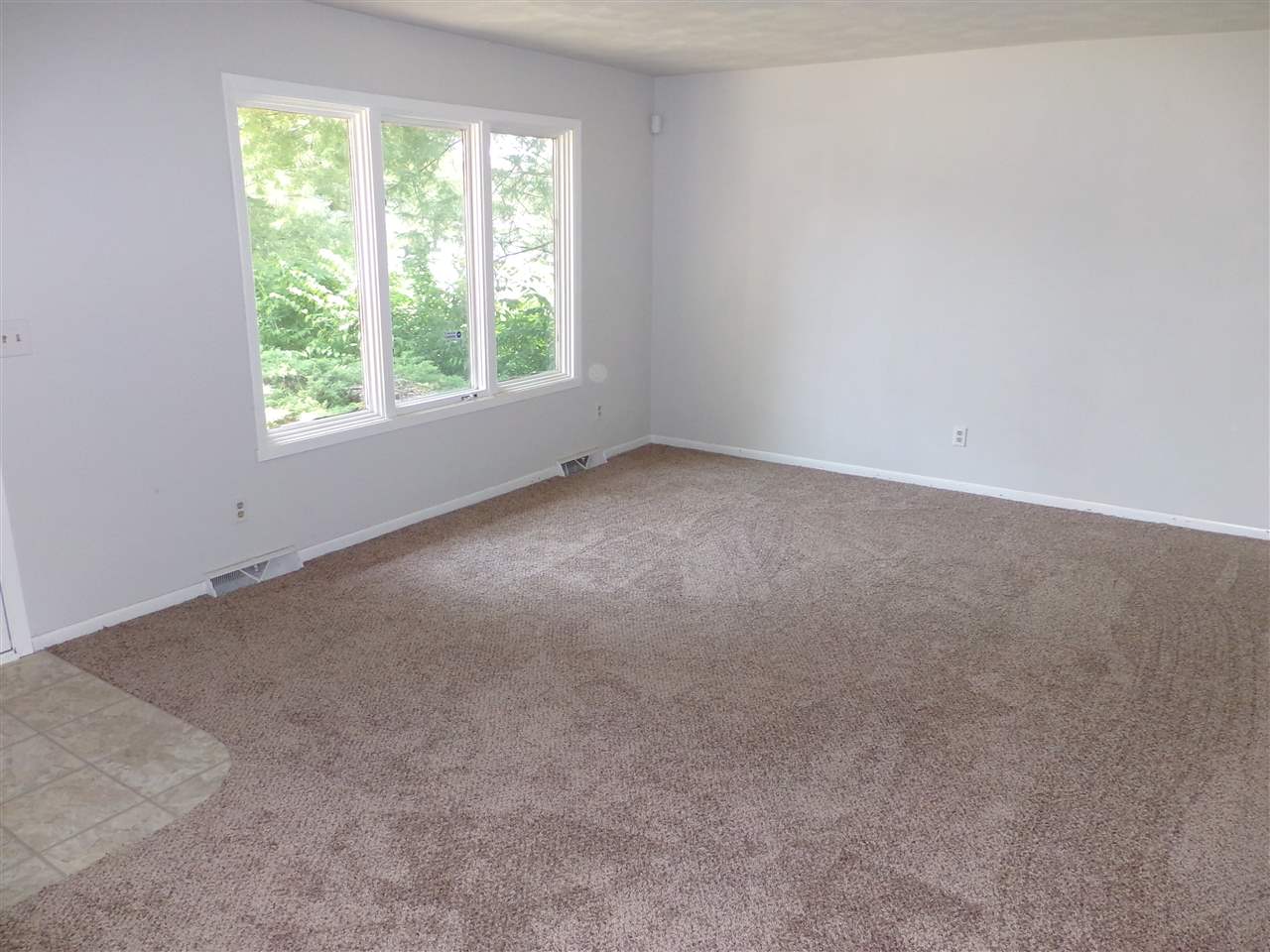 216 Rochester Road Northeast Poplar Grove, IL 61065 - Photo 5 of 17 an empty room with a window