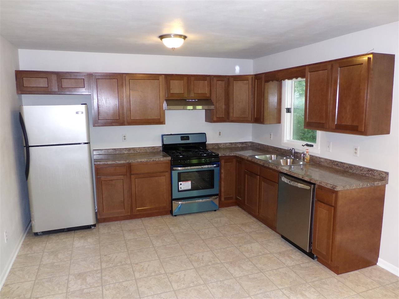 216 Rochester Road Northeast Poplar Grove, IL 61065 - Photo 6 of 17 a kitchen with a sink stove and refrigerator
