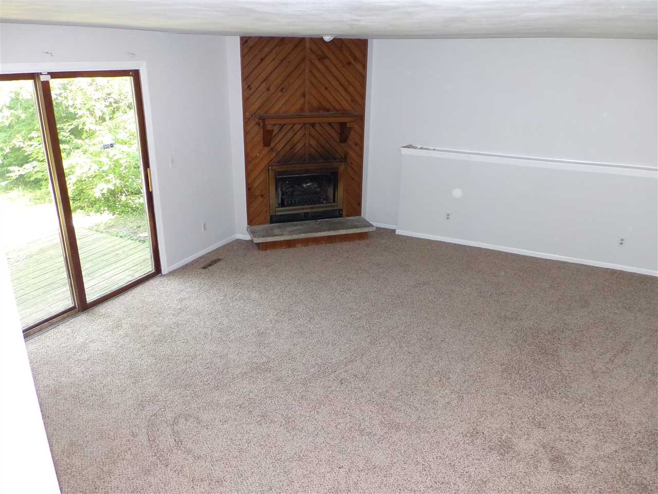 216 Rochester Road Northeast Poplar Grove, IL 61065 - Photo 8 of 17 a view of empty room with a fireplace