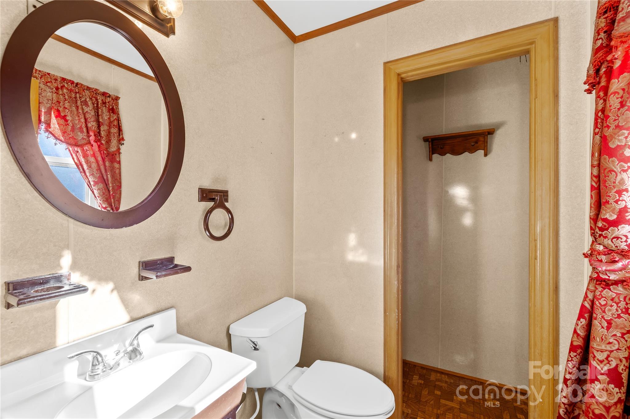 1208 Stallings Road Matthews, NC 28104 - Photo 13 of 18 a bathroom with a toilet a sink and a mirror