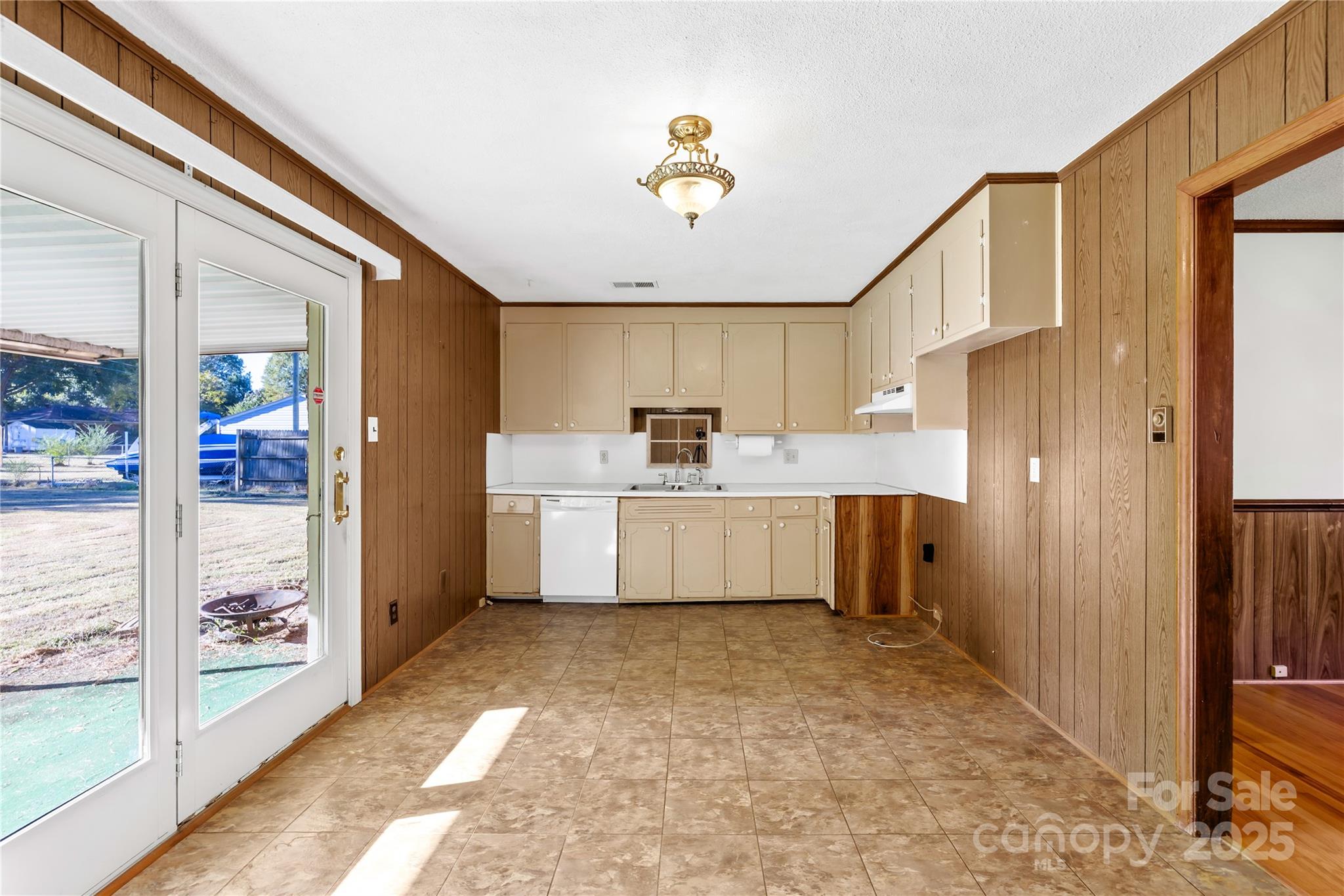 1208 Stallings Road Matthews, NC 28104 - Photo 15 of 18 a kitchen with stainless steel appliances a refrigerator sink and cabinets