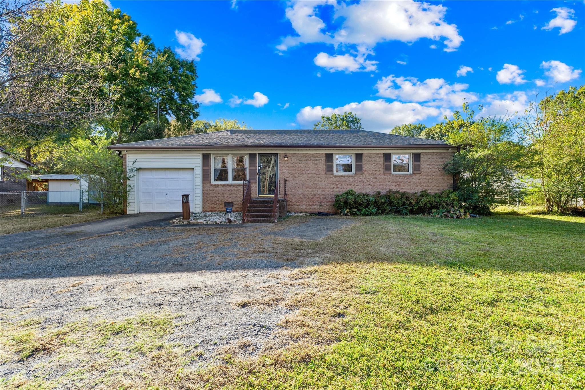 1208 Stallings Road Matthews, NC 28104 - Photo 2 of 18 a view of a yard in front of a house with large trees