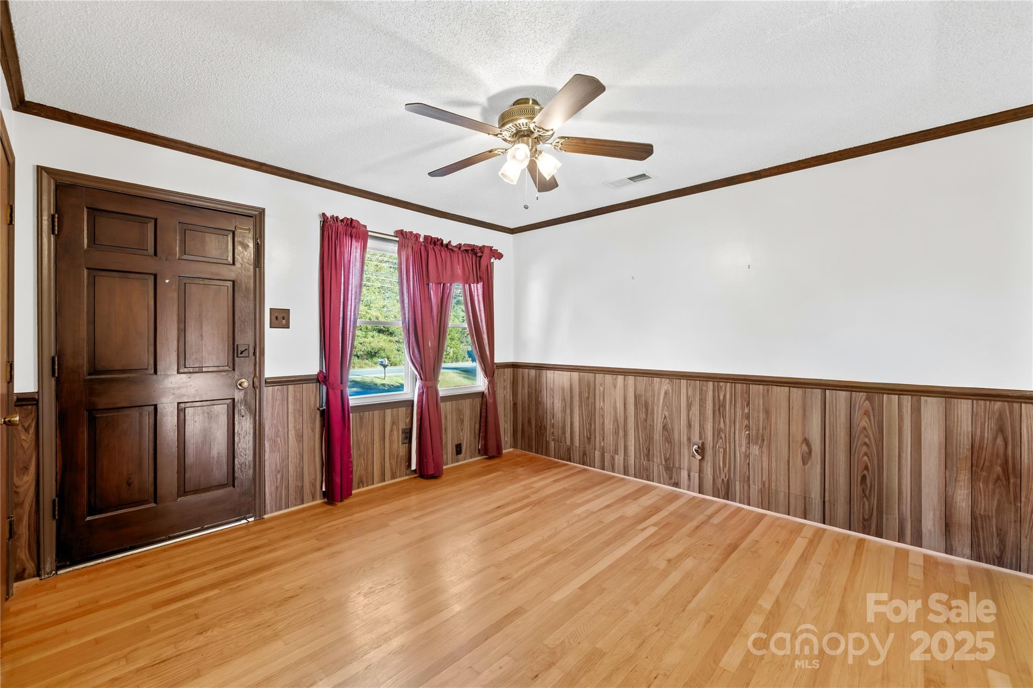 1208 Stallings Road Matthews, NC 28104 - Photo 8 of 18 a view of empty room with wooden floor and fan
