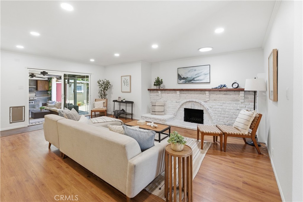 3327 North Studebaker Road Long Beach, CA 90808 - Photo 3 of 31 The living room is highlighted by the skylight, recessed, lighting, and the beautiful wood mantle.