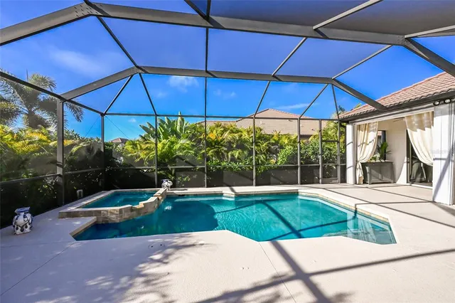 a view of a backyard with swimming area and tub