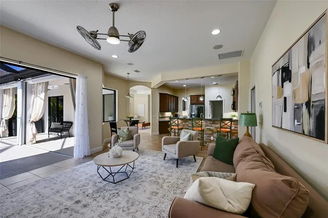 a living room with furniture and a chandelier