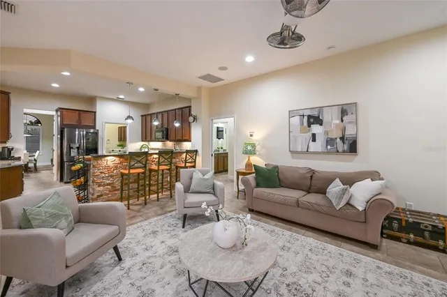 a living room with furniture kitchen view and a table