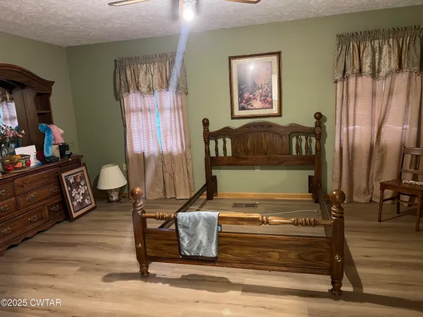 a living room with furniture and a painting on the wall