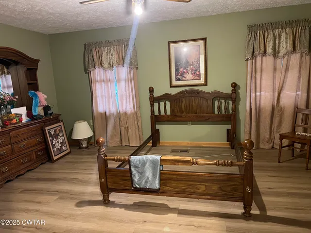 a living room with furniture and a painting on the wall