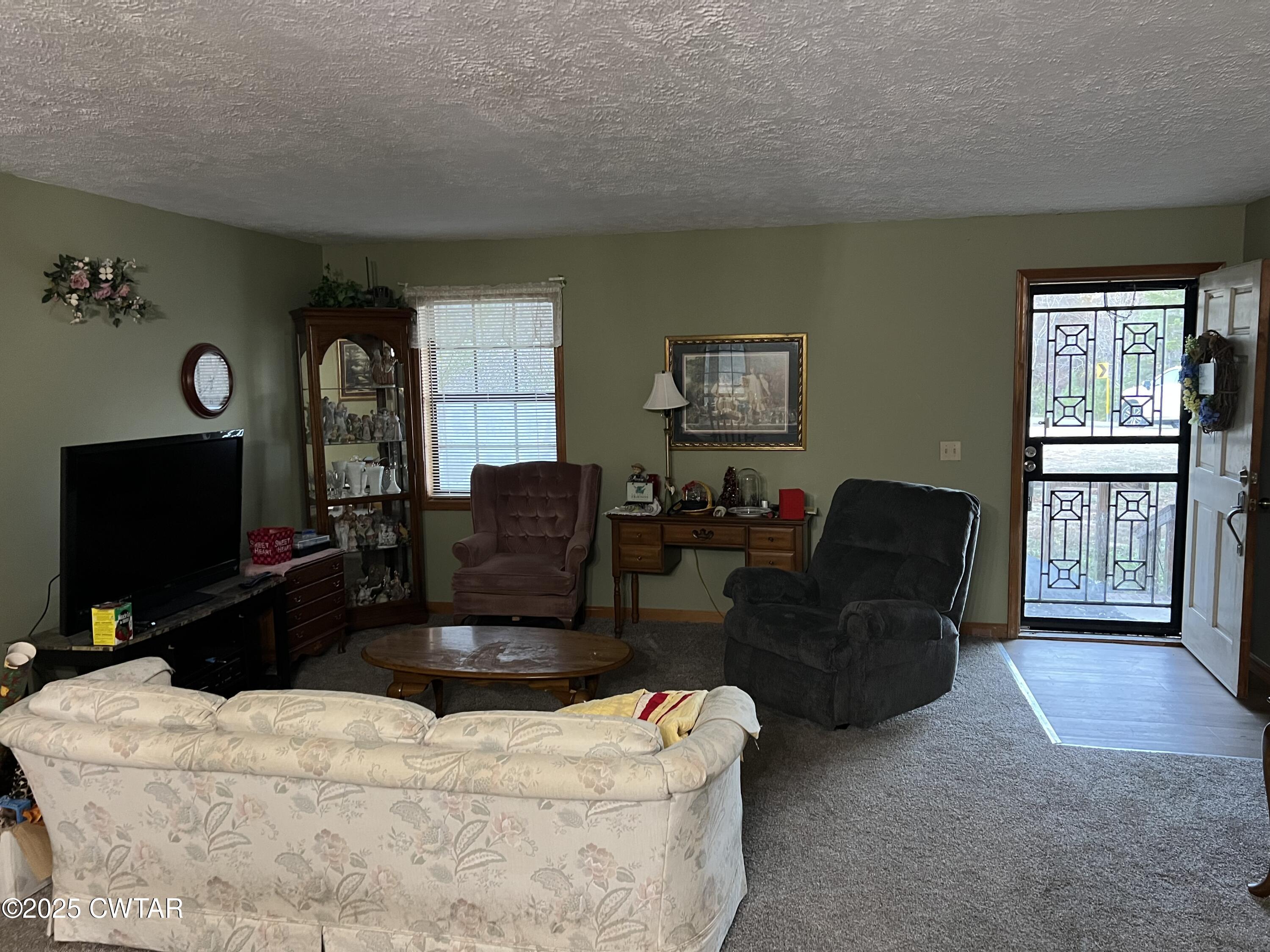 4335 Silerton Road Henderson, TN 38340 - Photo 2 of 24 a living room with furniture a flat screen tv and a window