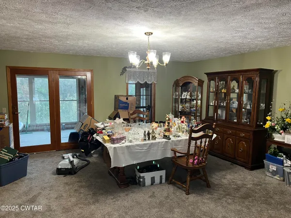 a view of a livingroom with furniture and a chandelier