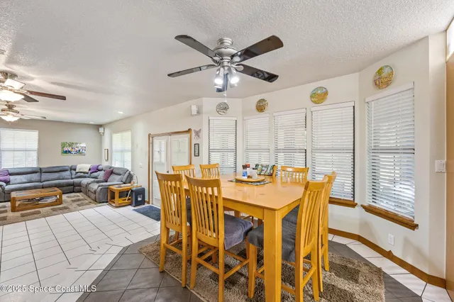 a view of a dining room with furniture and a large window