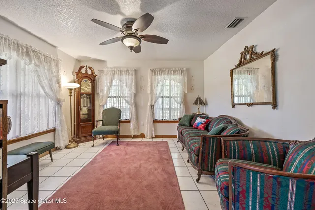 a living room with lots of furniture and a book shelf