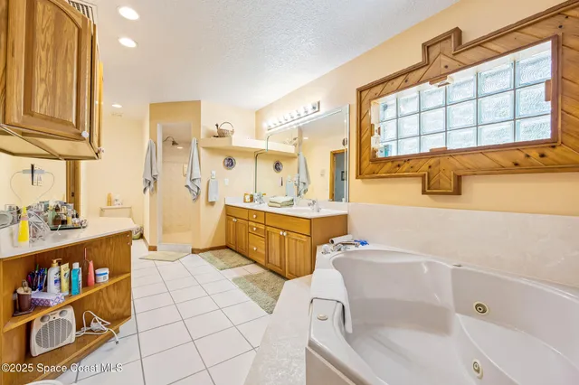 a bathroom with a sink mirror vanity bathtub and shower