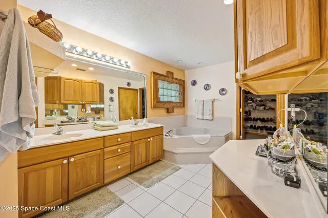 a large white kitchen with a large window