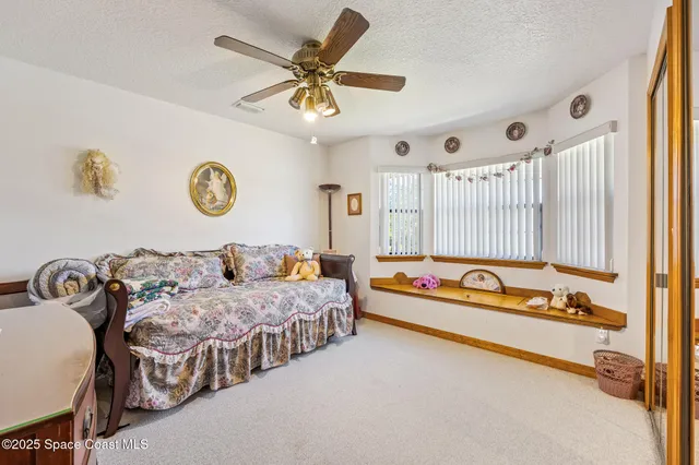 a spacious bedroom with two bed and a chandelier