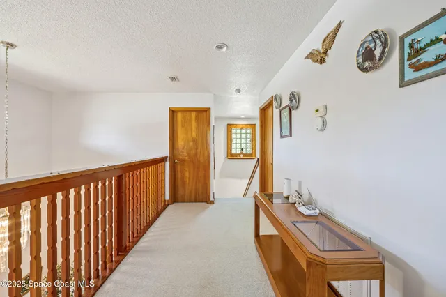 a view of a bedroom with wooden floor and bed