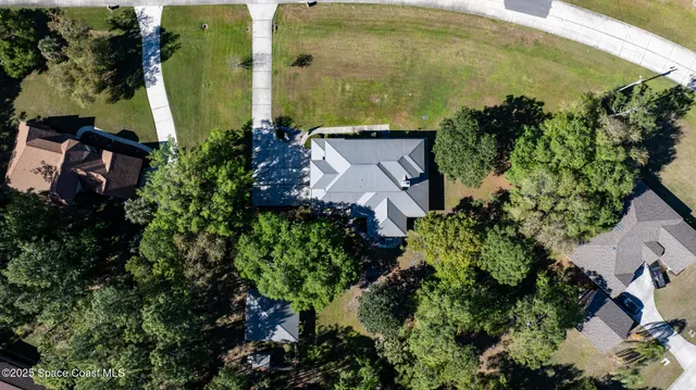 an aerial view of a house with a garden