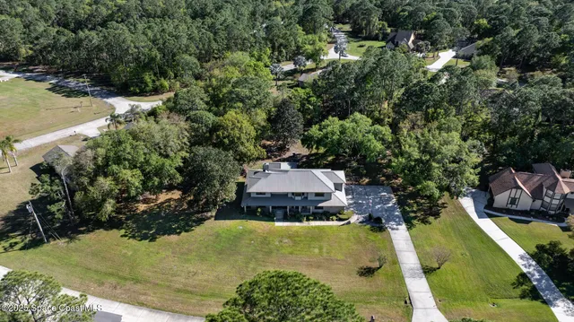 a aerial view of a house with swimming pool