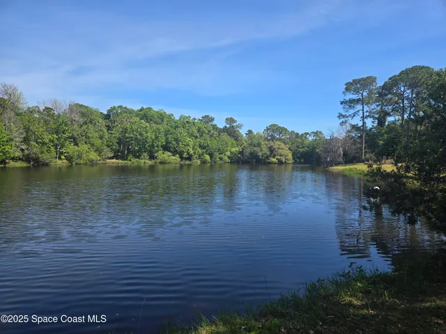 a view of a lake with houses in the back