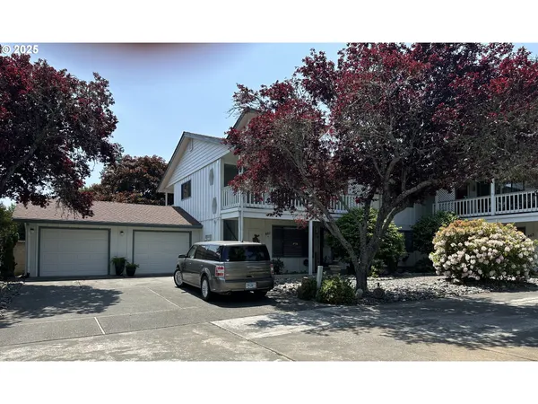 a car parked in front of white house