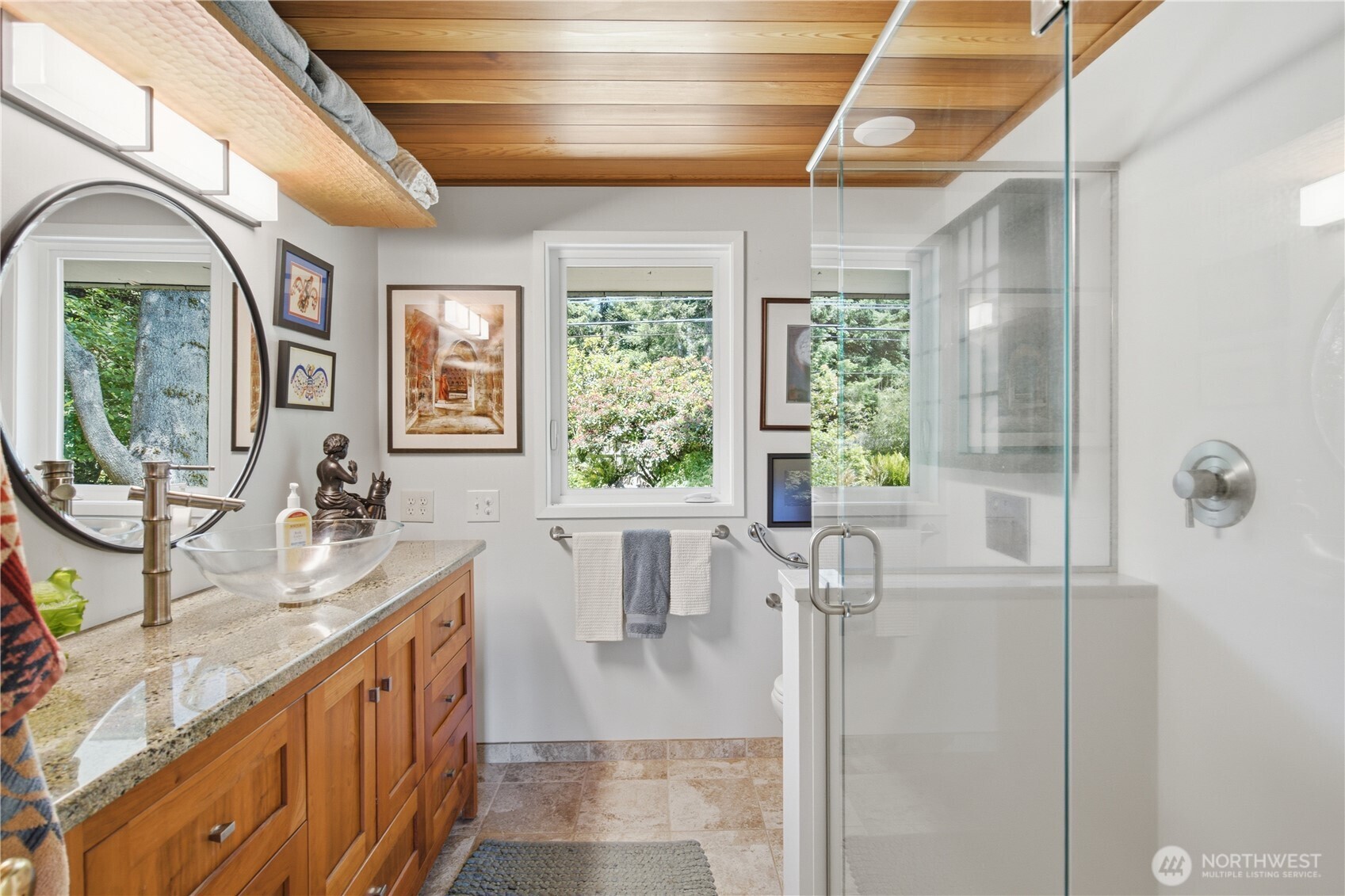 3050 Southeast Mullenix Road Port Orchard, WA 98367 - Photo 25 of 40 a bathroom with a double vanity sink a mirror and a bathtub