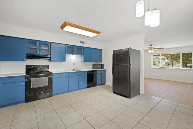 a kitchen with stainless steel appliances a refrigerator and a stove top oven