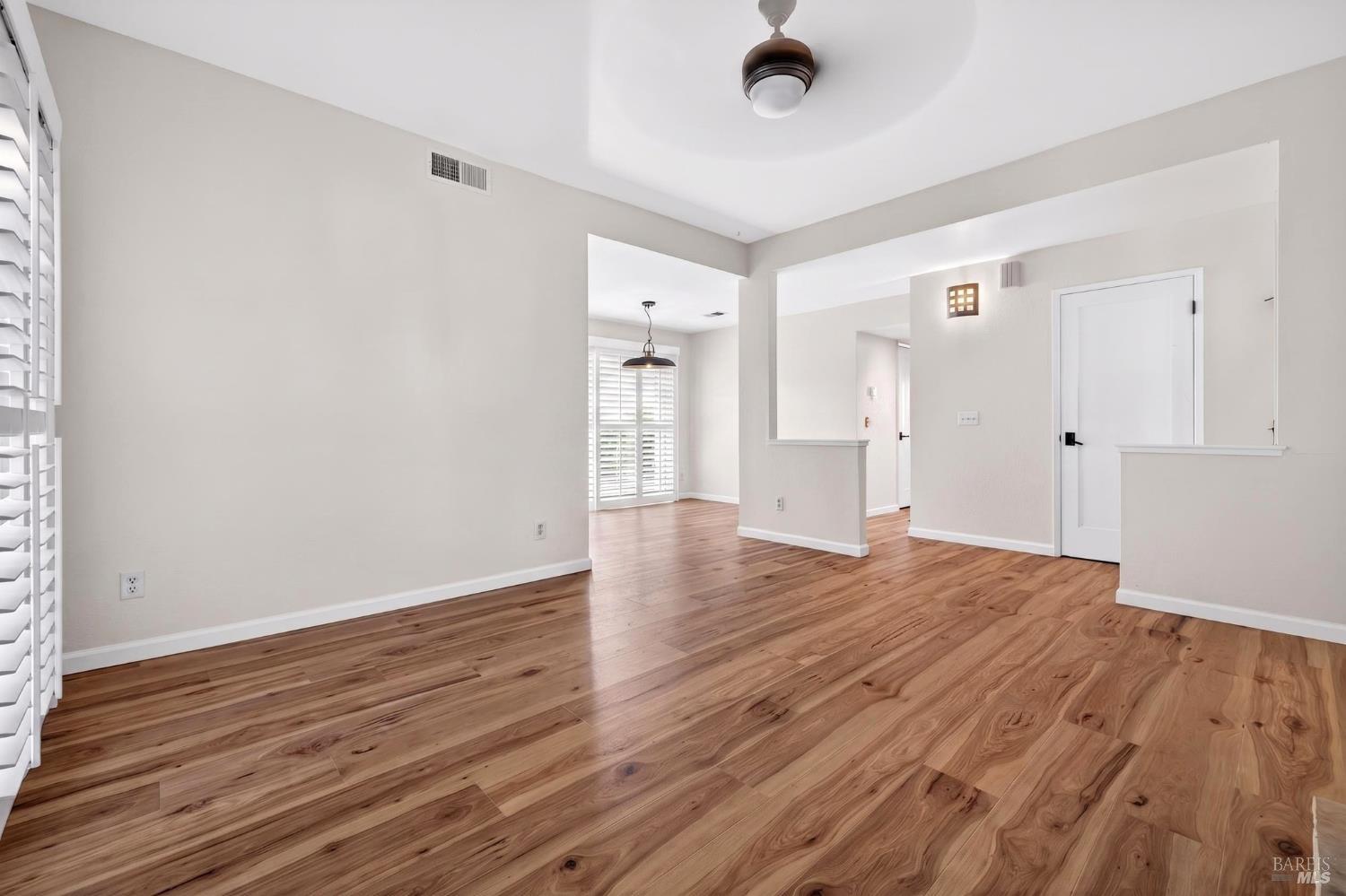 2757 Lakeview Drive Santa Rosa, CA 95405 - Photo 7 of 54 a view of an empty room with wooden floor and a window