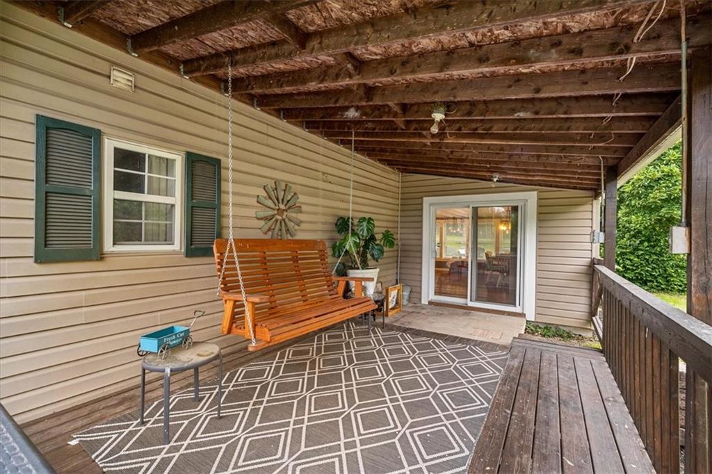 172 Queen Junction Road Butler, PA 16001 - Photo 26 of 38 a view of a porch with wooden floor and iron stairs