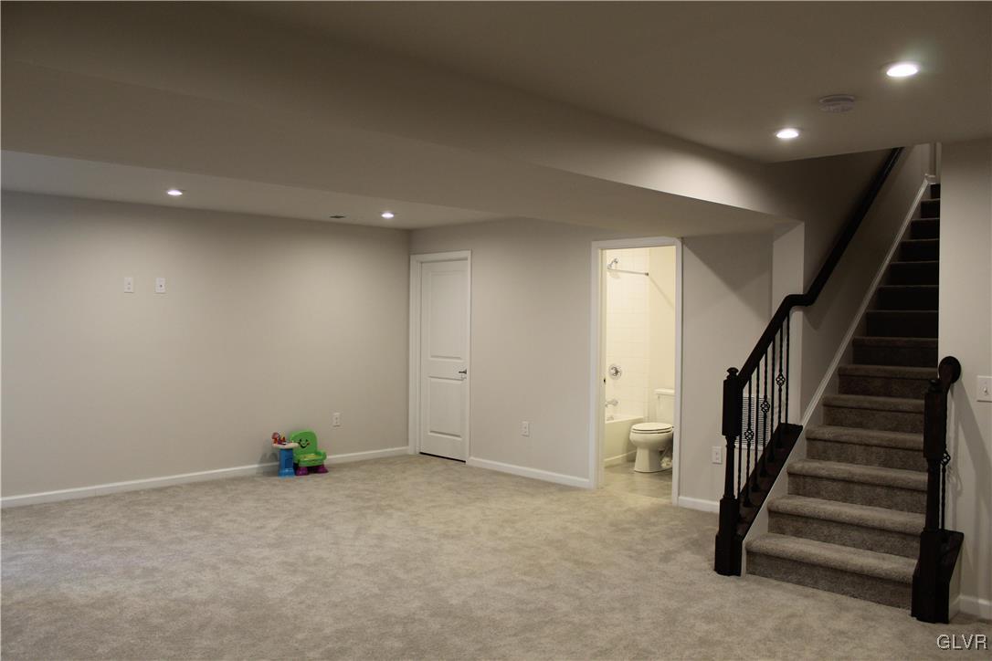 2584 Raya Way Easton, PA 18045 - Photo 20 of 35 an empty room with wooden floor and stairs