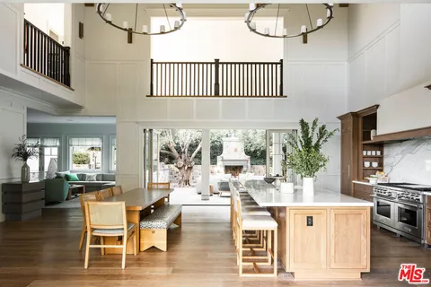 a view of cabinets and utility room with wooden floor