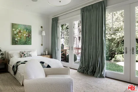 a living room with furniture a rug and a dining table