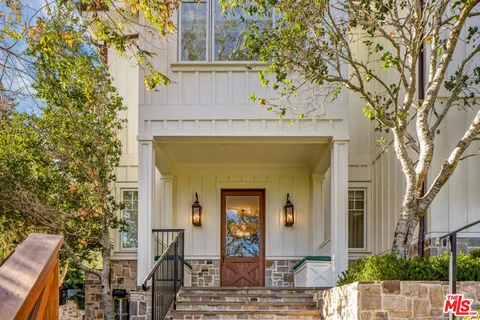 a front view of a house with trees