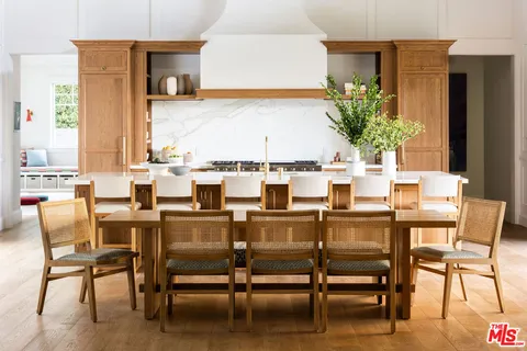 a view of a dining room with furniture wooden floor and chandelier