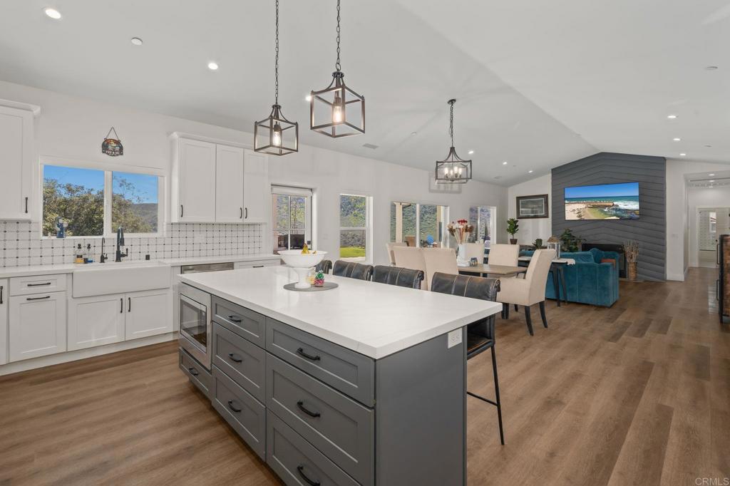 15663 Mathew Road Valley Center, CA 92082 - Photo 17 of 54 a large kitchen with a center island appliances and cabinets
