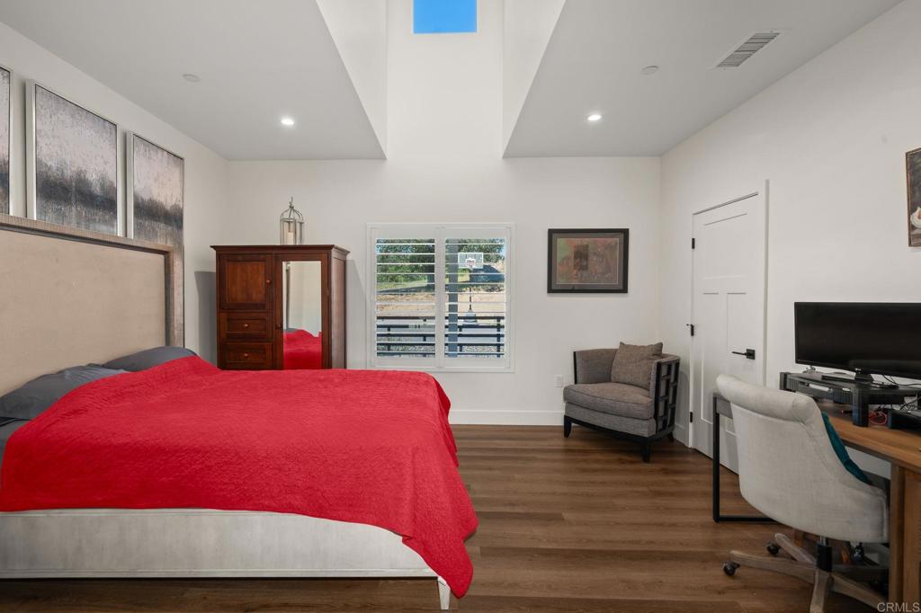 15663 Mathew Road Valley Center, CA 92082 - Photo 21 of 54 a bedroom with a bed and wooden floor
