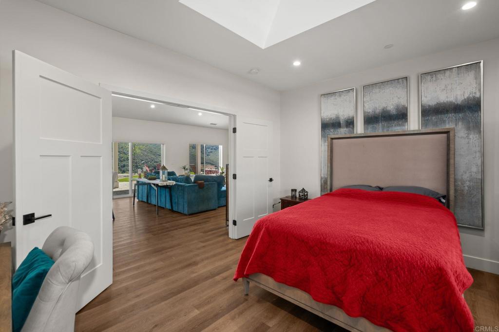 15663 Mathew Road Valley Center, CA 92082 - Photo 22 of 54 a bedroom with a bed and wooden floor