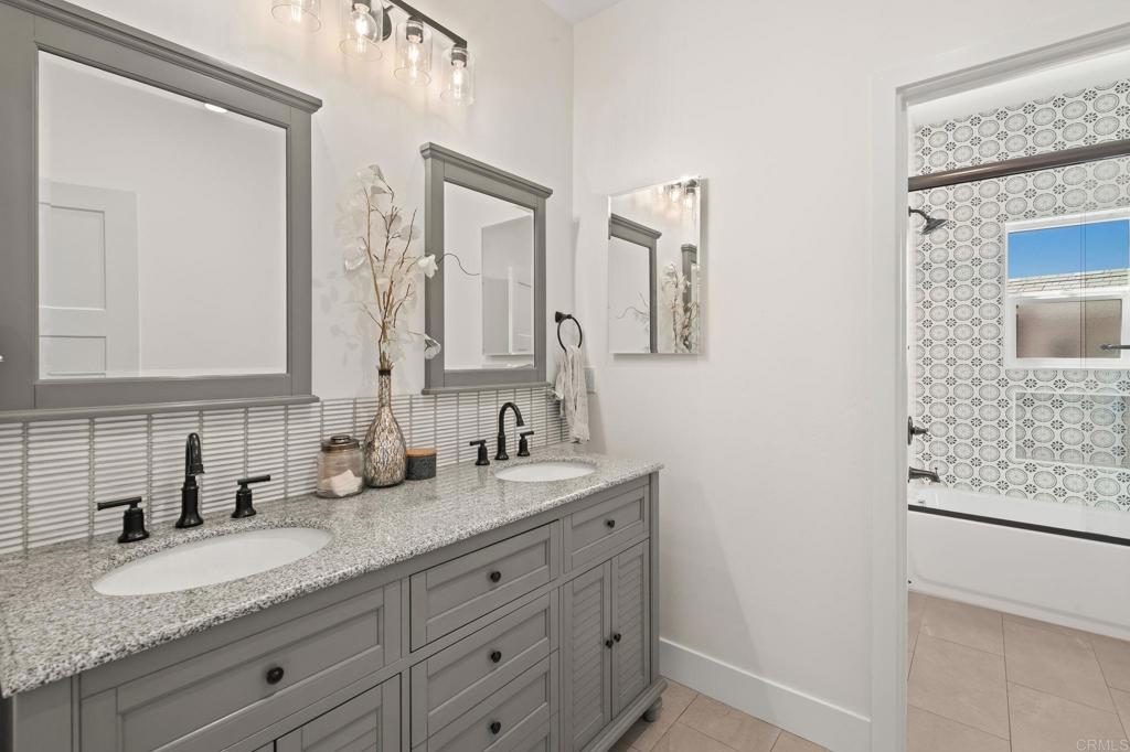 15663 Mathew Road Valley Center, CA 92082 - Photo 26 of 54 a bathroom with double sink and a mirror