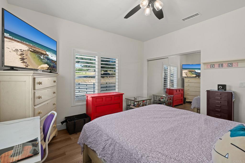 15663 Mathew Road Valley Center, CA 92082 - Photo 29 of 54 a bedroom with bed and wooden floor