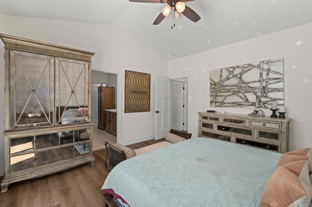 15663 Mathew Road Valley Center, CA 92082 - Photo 31 of 54 a bedroom with a bed and a chandelier