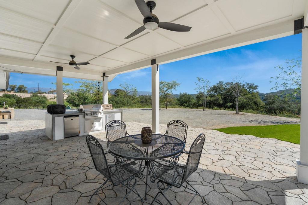 15663 Mathew Road Valley Center, CA 92082 - Photo 35 of 54 a view of a patio with a dining table and chairs