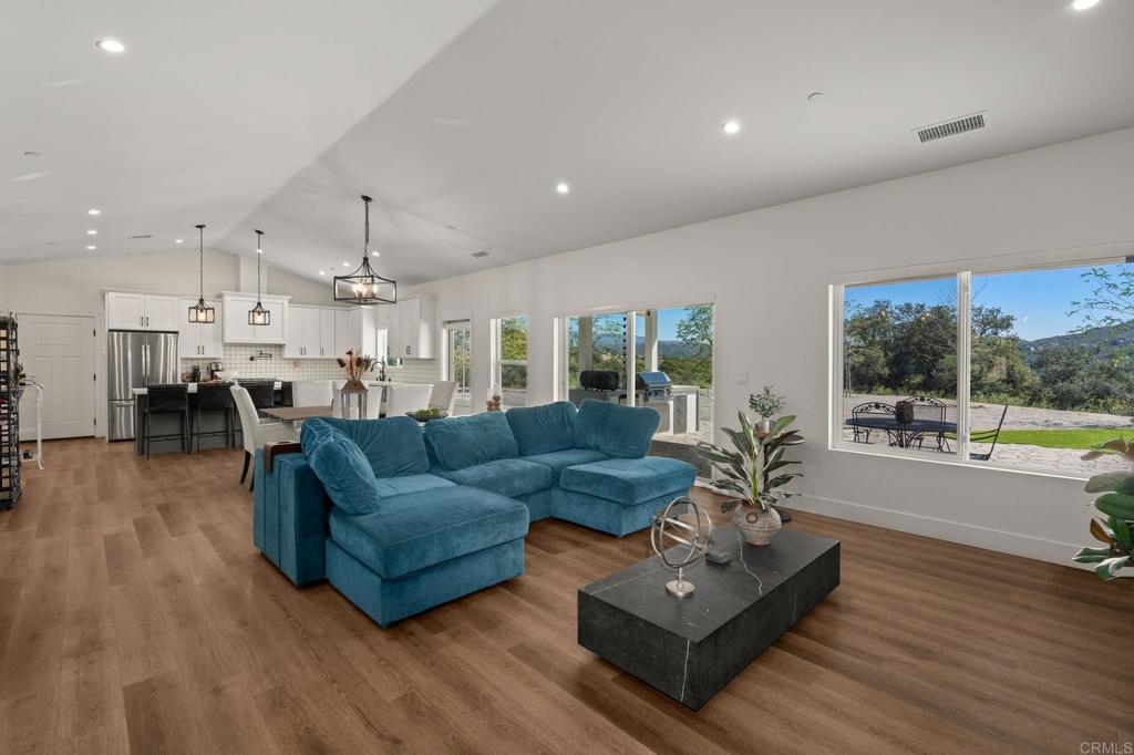 15663 Mathew Road Valley Center, CA 92082 - Photo 4 of 54 a living room with furniture and a wooden floor