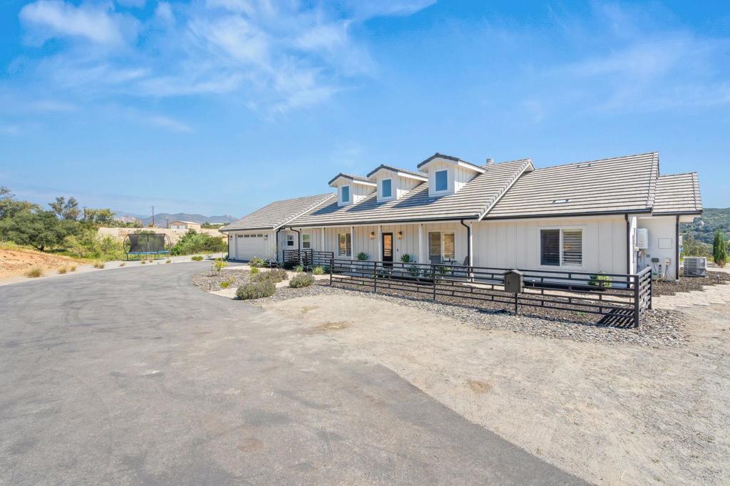 15663 Mathew Road Valley Center, CA 92082 - Photo 44 of 54 a front view of a house with a yard and sitting area