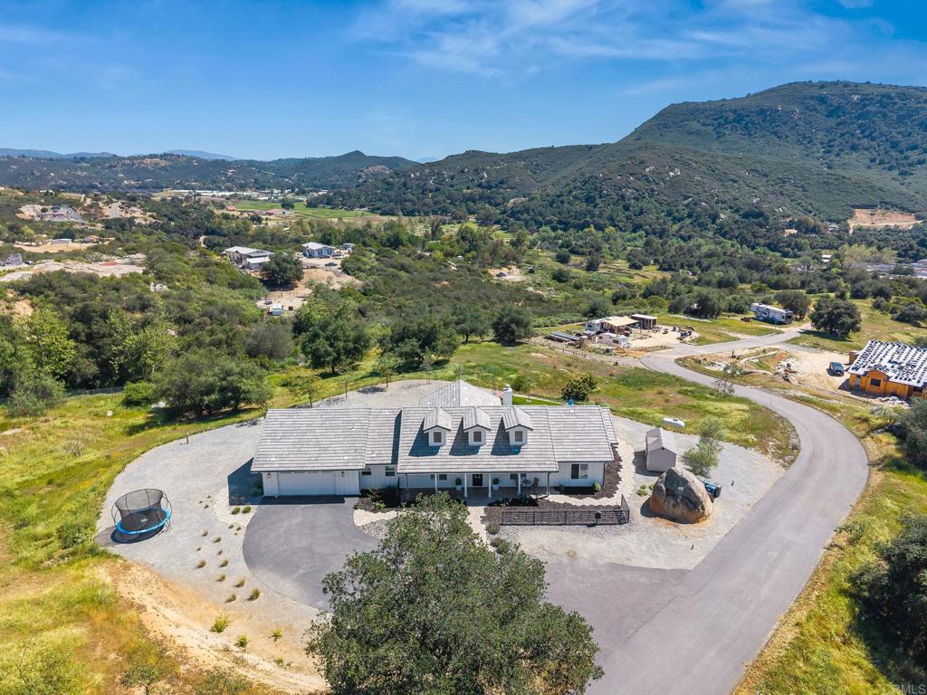 15663 Mathew Road Valley Center, CA 92082 - Photo 45 of 54 a view of a house with a yard and lake view