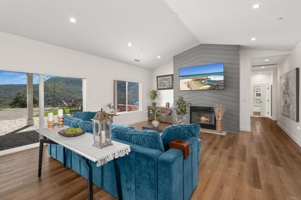 15663 Mathew Road Valley Center, CA 92082 - Photo 7 of 54 a living room with fireplace furniture and a table