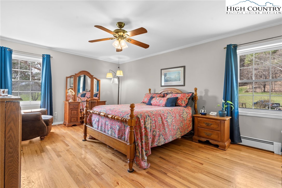 883 Bald Mountain Road West Jefferson, NC 28694 - Photo 11 of 47 a bedroom with a bed and wooden floor