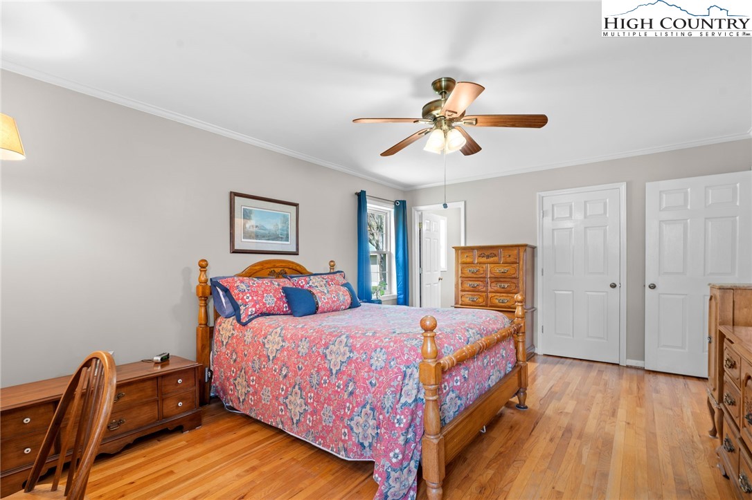 883 Bald Mountain Road West Jefferson, NC 28694 - Photo 12 of 47 a bedroom with a bed and wooden floor