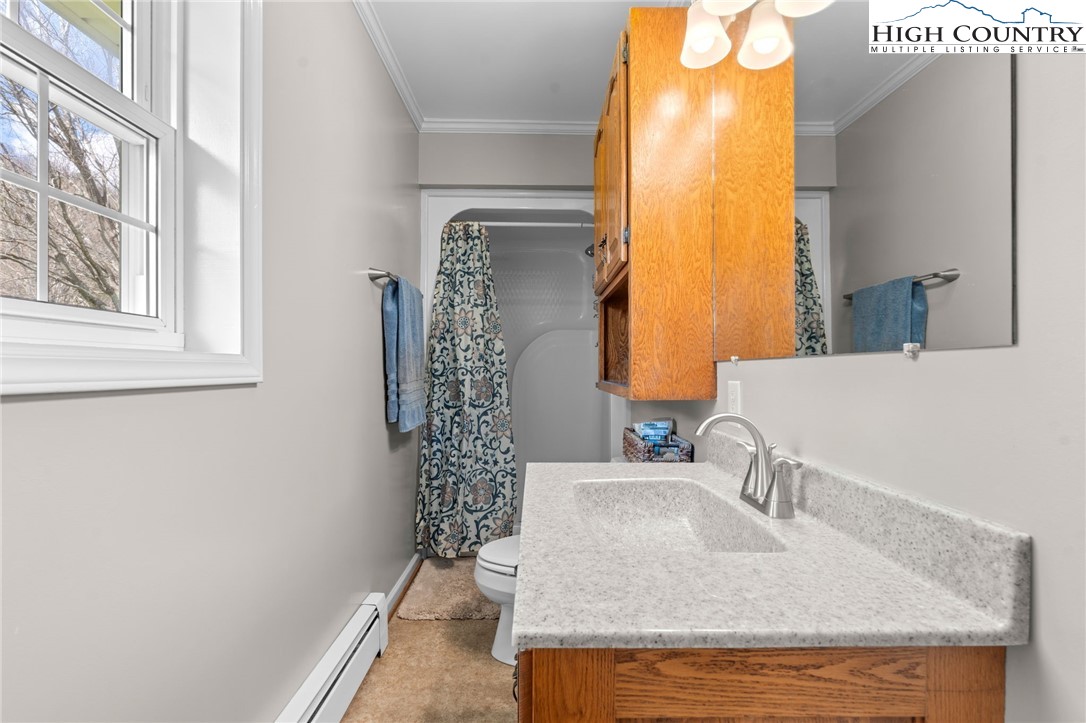 883 Bald Mountain Road West Jefferson, NC 28694 - Photo 13 of 47 a bathroom with a granite countertop sink and a mirror