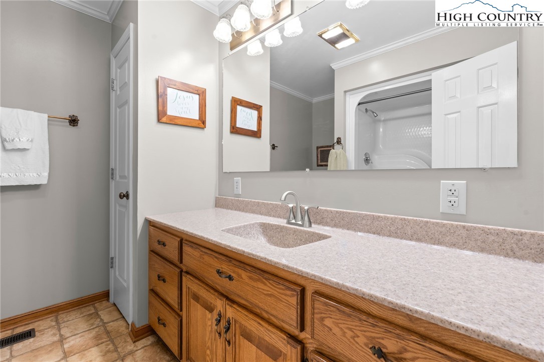 883 Bald Mountain Road West Jefferson, NC 28694 - Photo 15 of 47 a bathroom with a sink a vanity and mirror