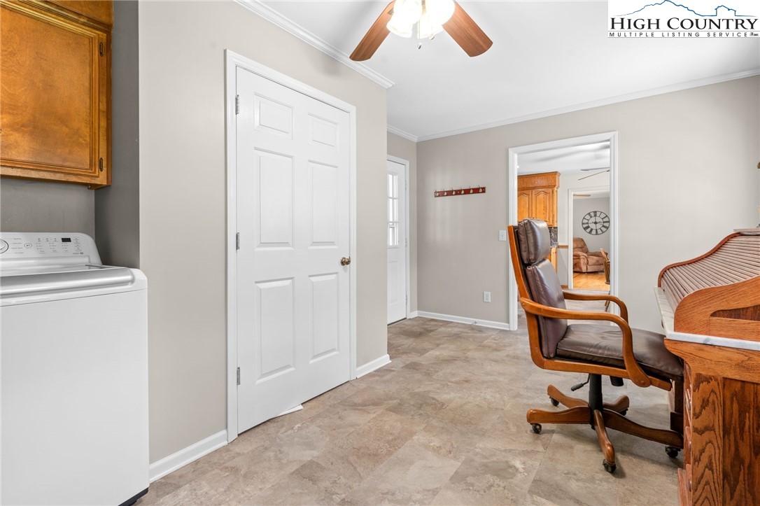 883 Bald Mountain Road West Jefferson, NC 28694 - Photo 19 of 47 a view of a workspace with furniture and a window
